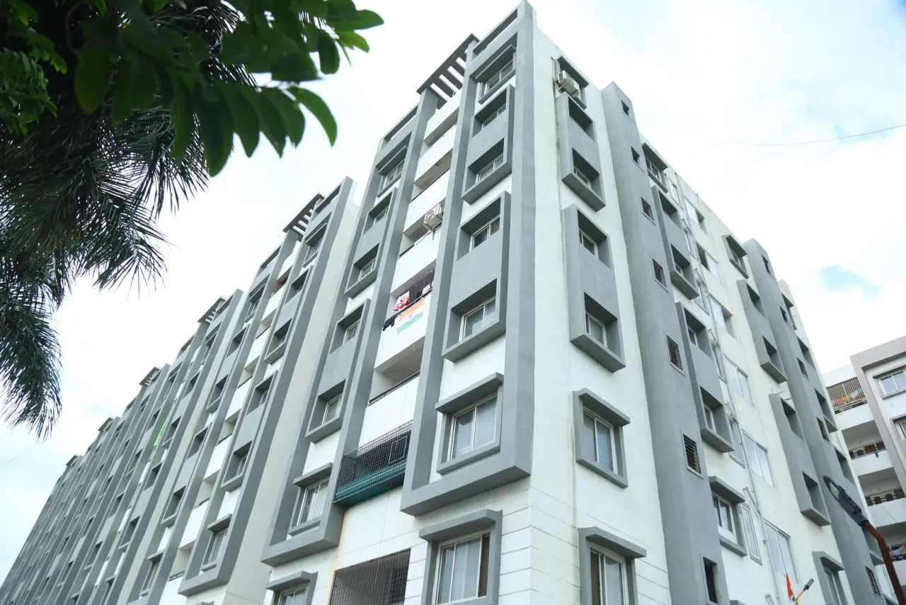 High-rise apartment building captured from a low-angle view, showcasing clean architecture and vertical design — photographed by New Branding Partner.