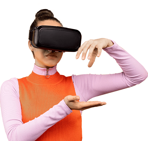 A woman in a pink full-sleeve top and orange sweater wearing a VR headset, reaching forward to interact with a virtual environment — representing New Branding Partner’s focus on immersive digital experiences.